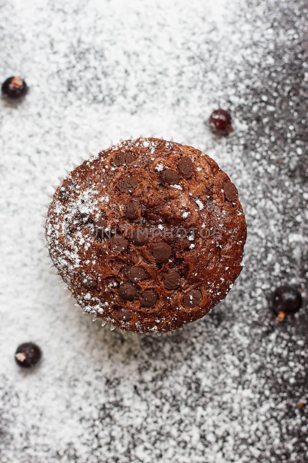 Chocolate cake on a black table with powdered sugar