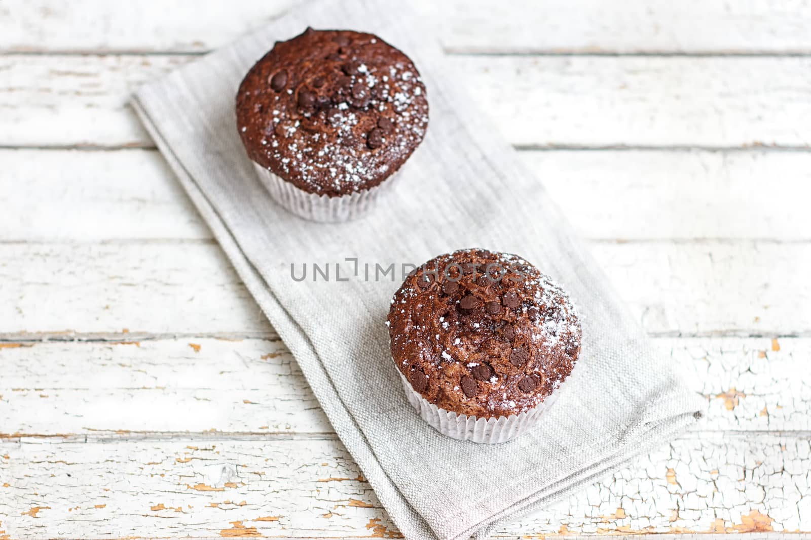 Two chocolate muffin on a fabric napkin