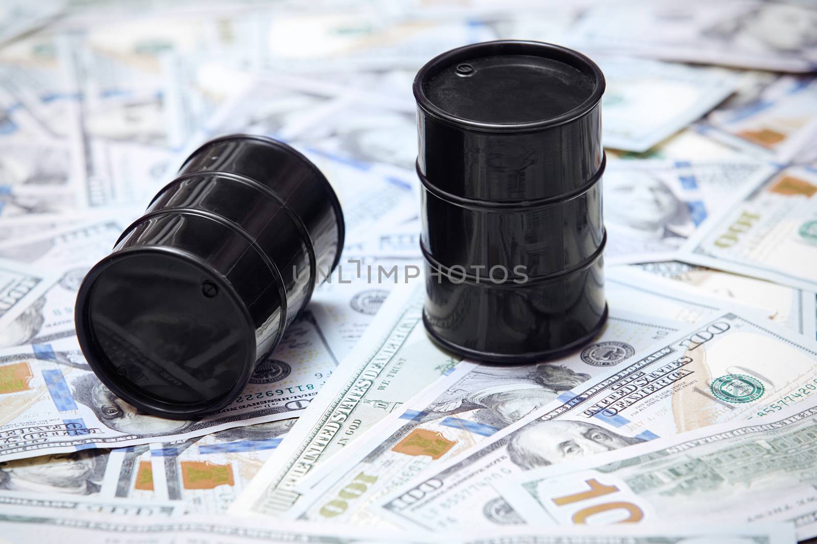 Oil drums on US dollars background