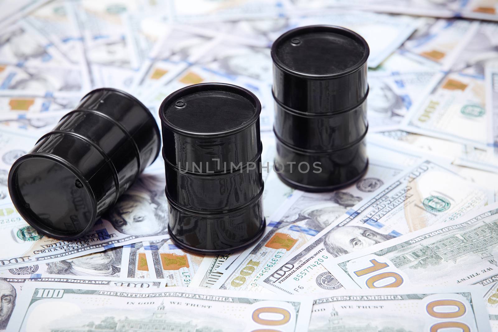 Oil drums on US dollars background by Novic
