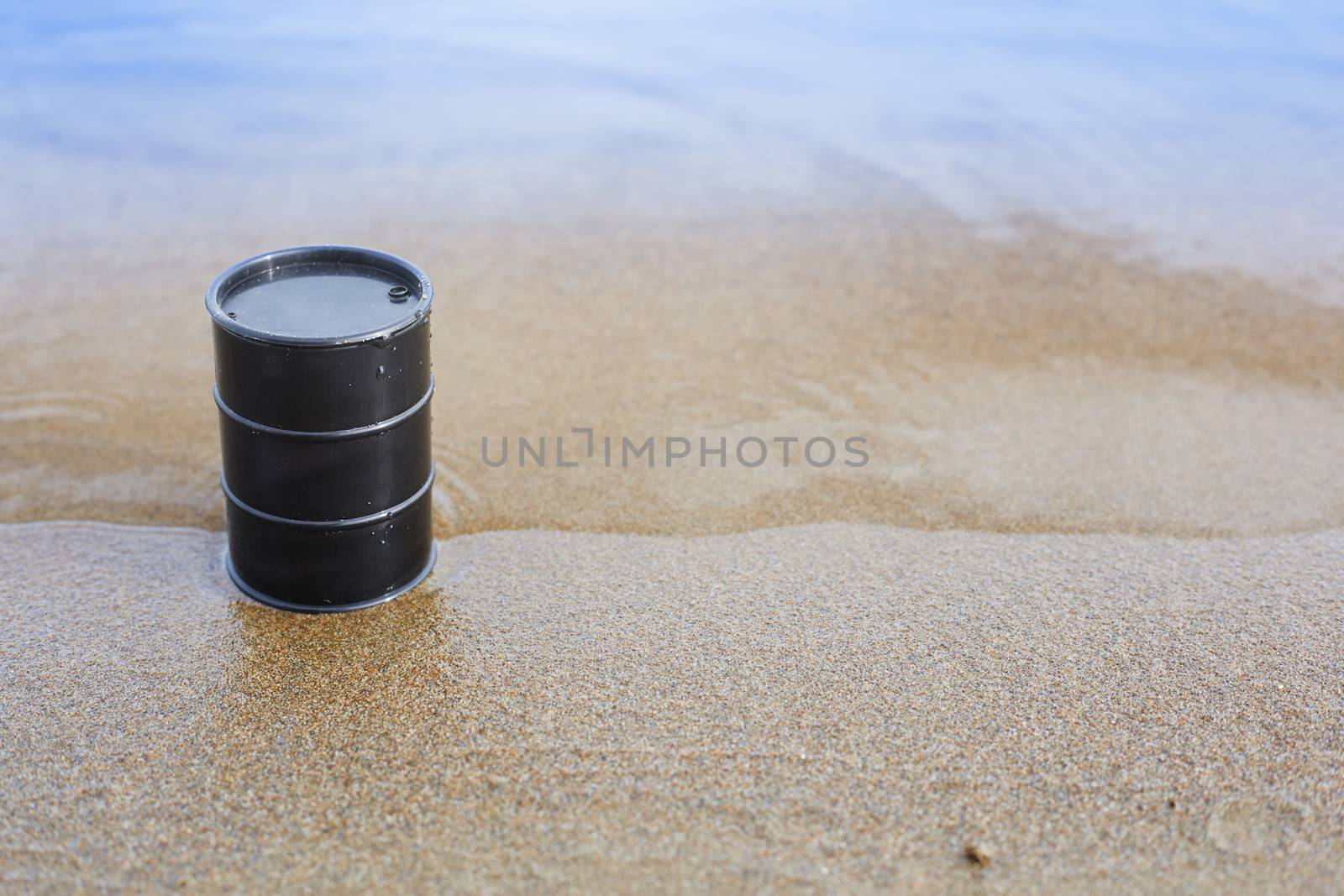 Oil barrel abandoned at the sea coast