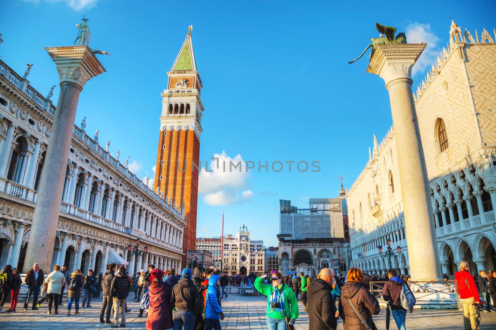 VENICE - NOVEMBER 22: San Marco square with tourists on November 22, 2015 in Venice, Italy. It's the principal public square of Venice, Italy, where it is generally known just as the Piazza.