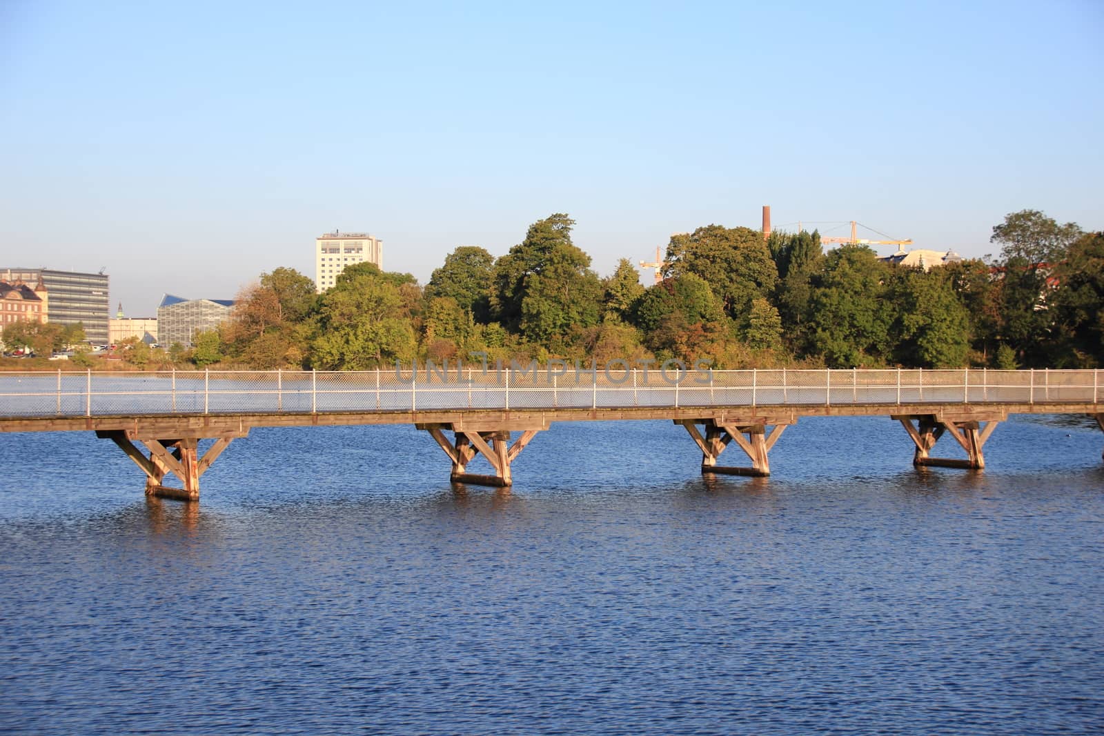 Bridge over blue water in city lake