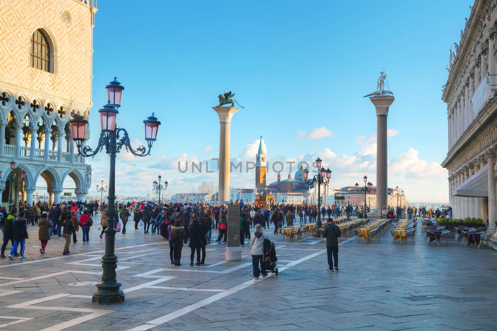 VENICE - NOVEMBER 22: San Marco square with tourists on November 22, 2015 in Venice, Italy. It's the principal public square of Venice, where it is generally known just as the Piazza.