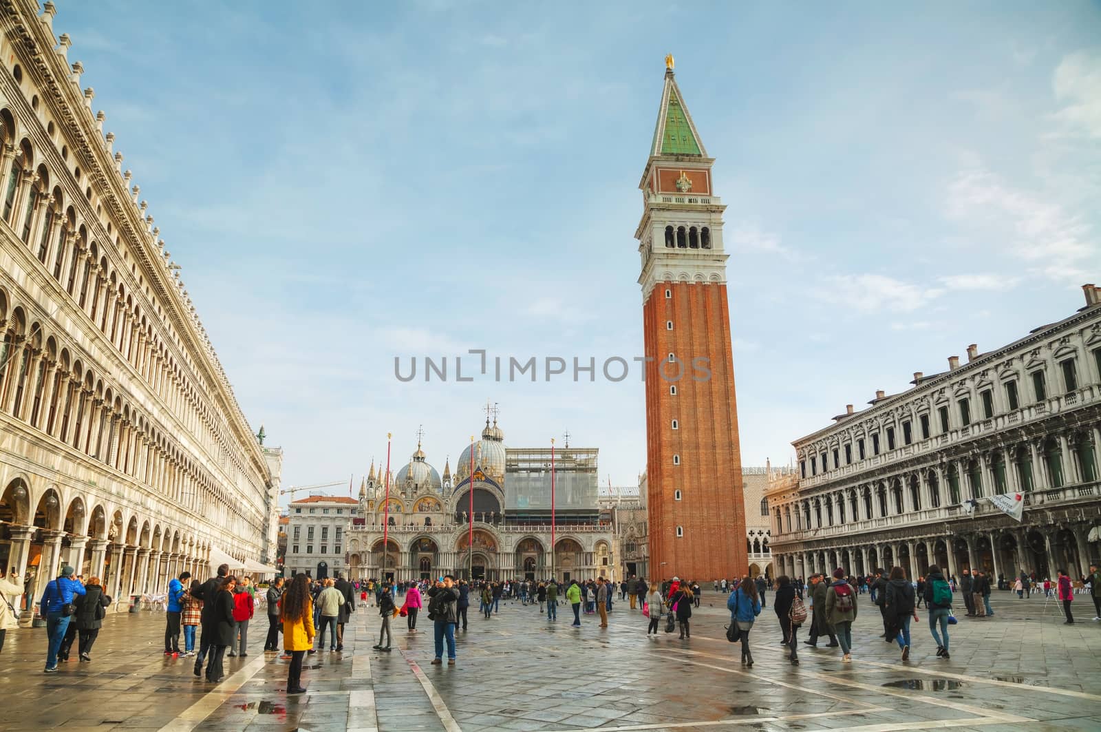 VENICE - NOVEMBER 22: San Marco square with tourists on November 22, 2015 in Venice, Italy. It's the principal public square of Venice, Italy, where it is generally known just as the Piazza.