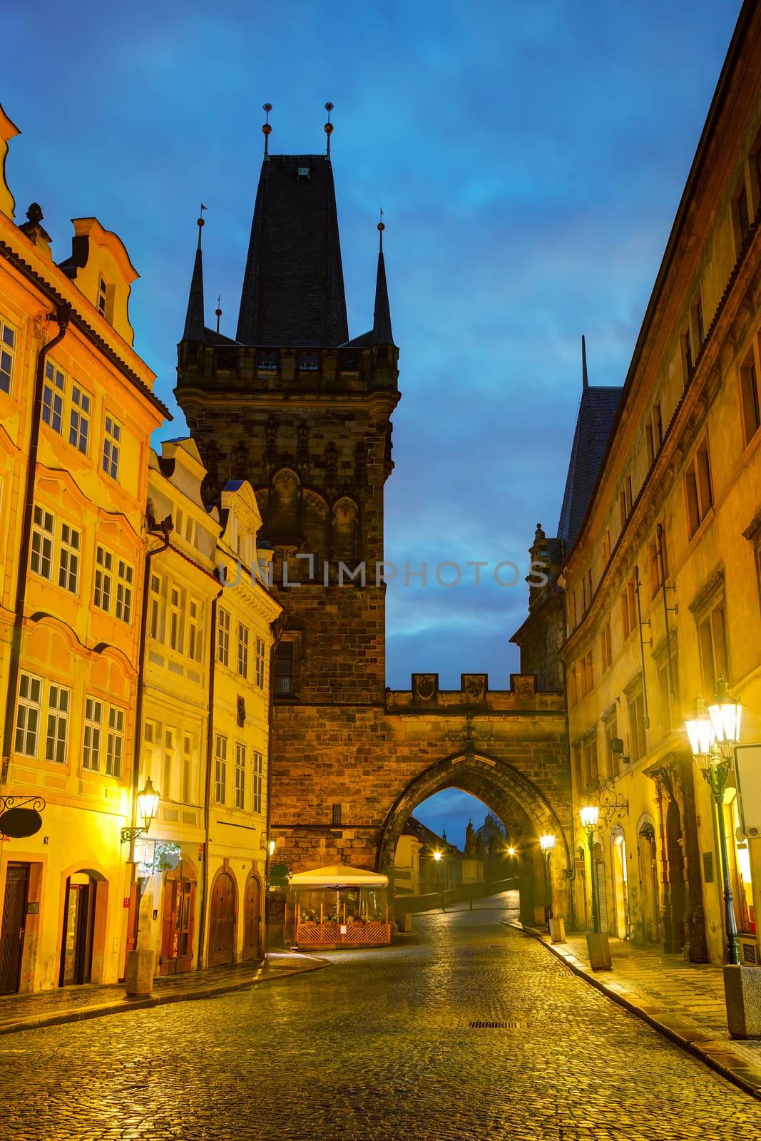 Old Prague street with Charles bridge in the morning