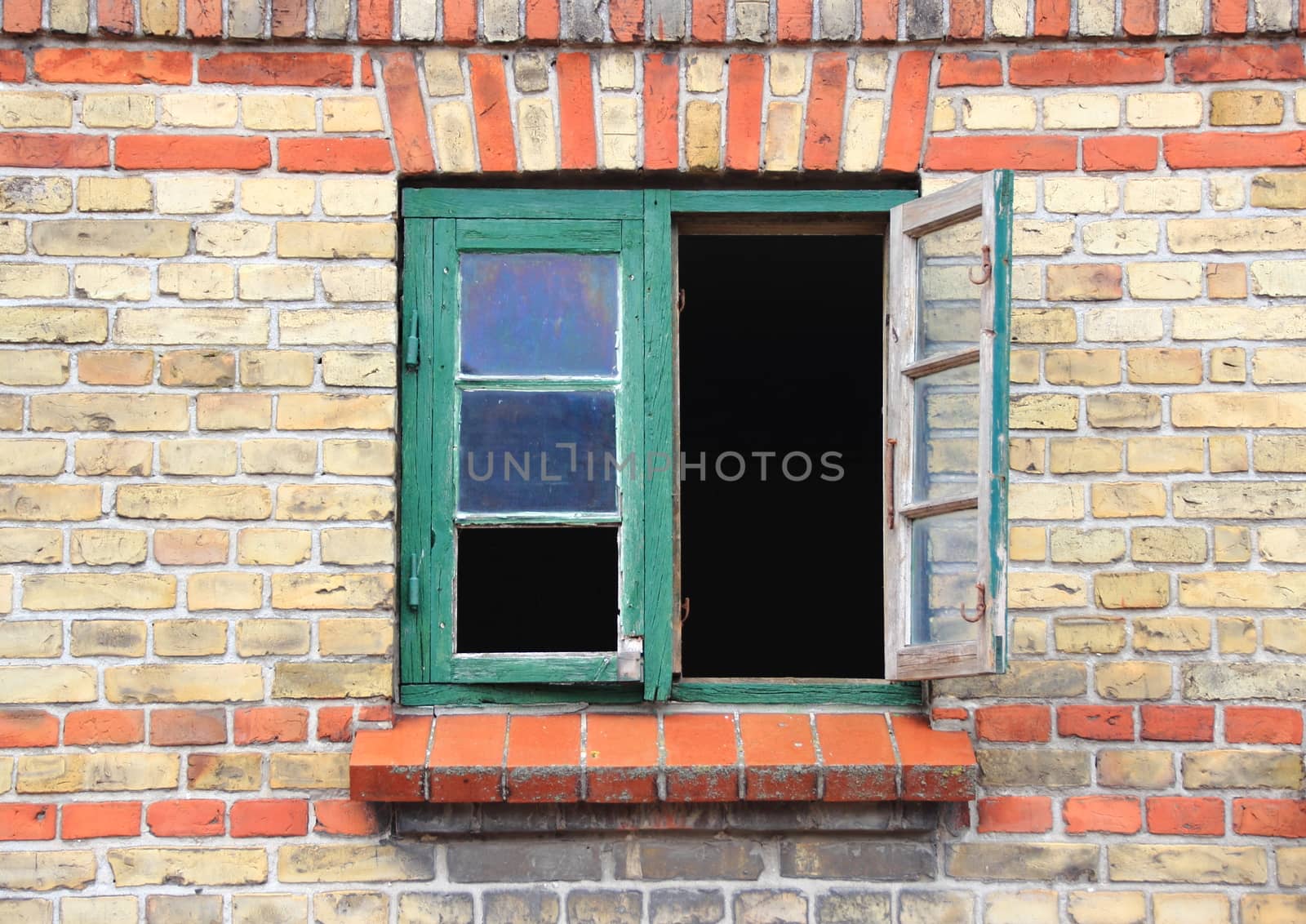 Open window with green frame and missing glass