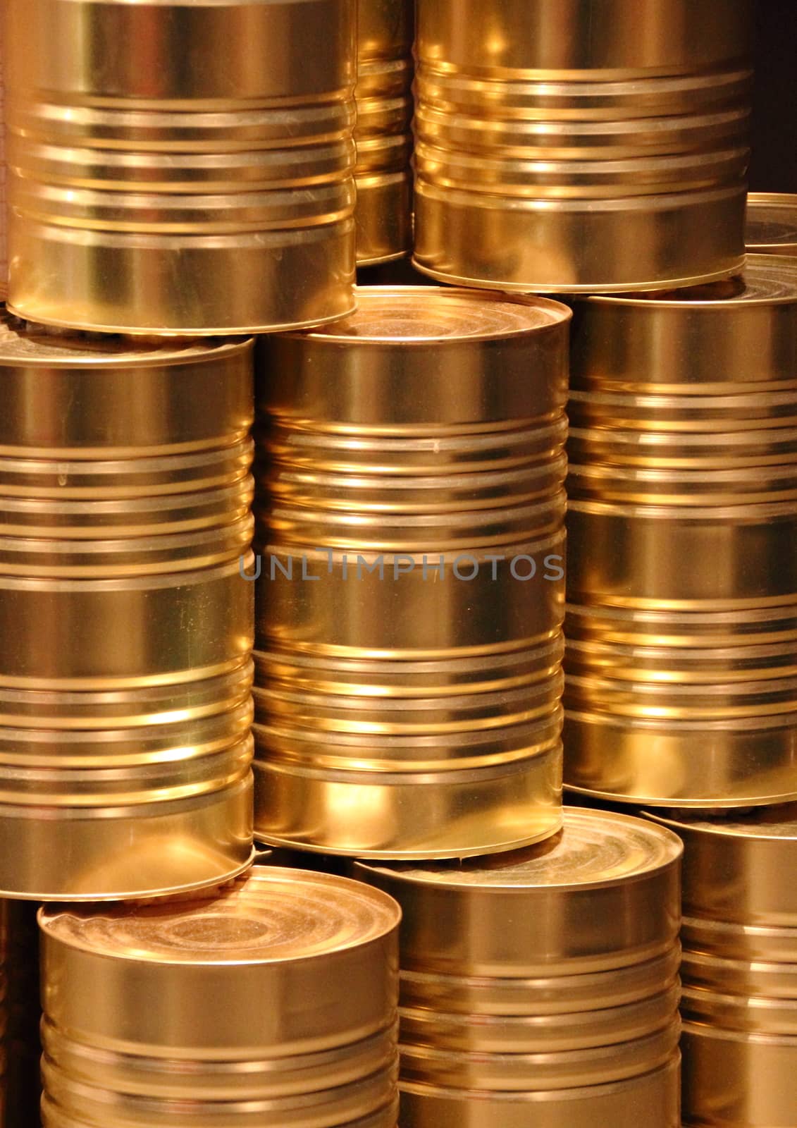 Vertical stack of golden metal food can background by HoleInTheBox