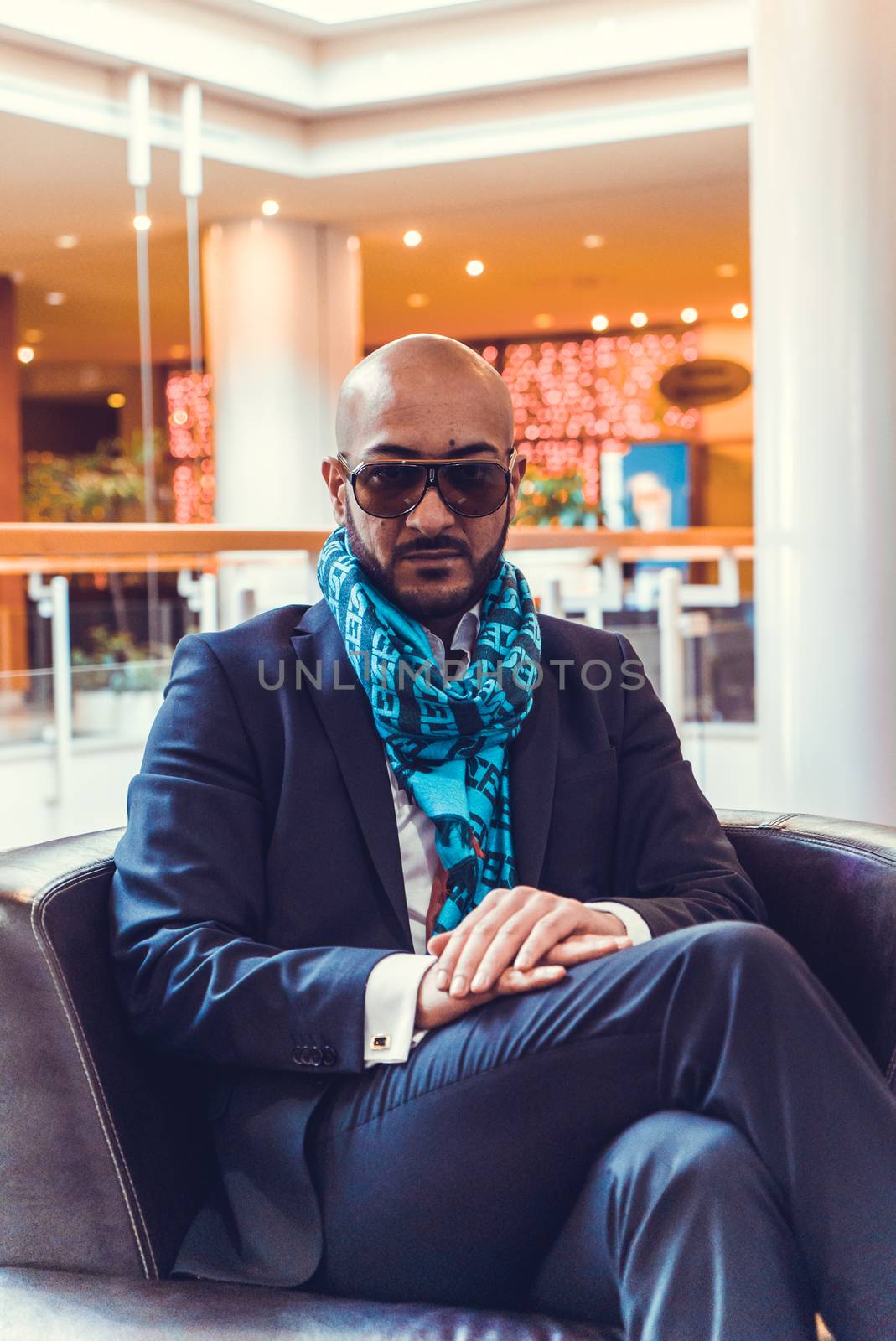 Arab businessman sitting on a sofa in an expensive hotel