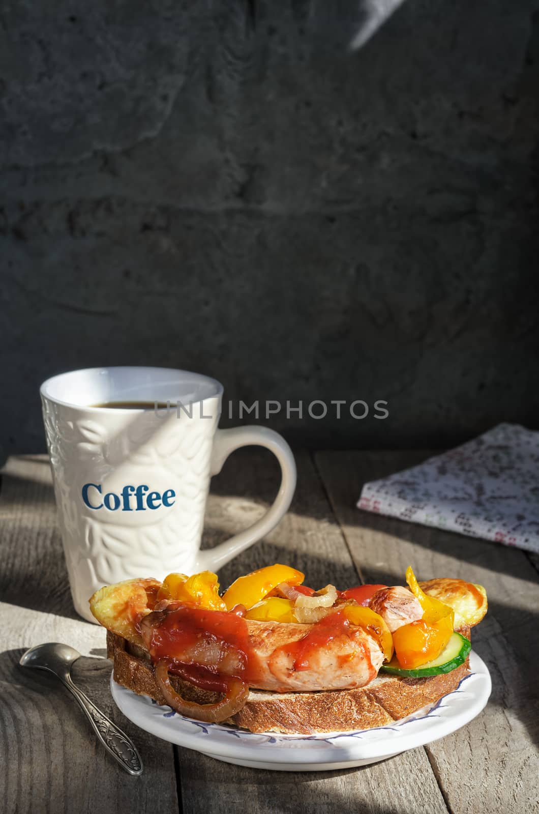 Sandwich with grilled sausages on a plate and coffee mug by Gaina