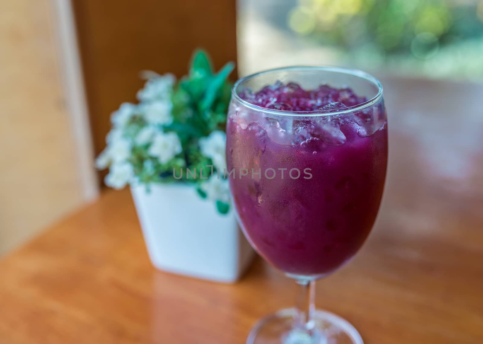 Glass of grape juice with ice