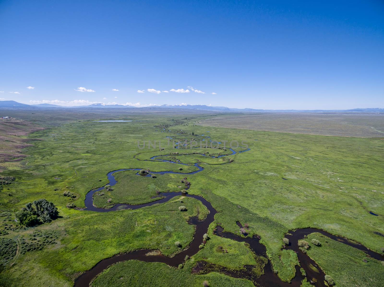 Illinois River meanders through Arapaho National Wildlife Refuge, North Park near Walden, Colorado, early summer aerial view