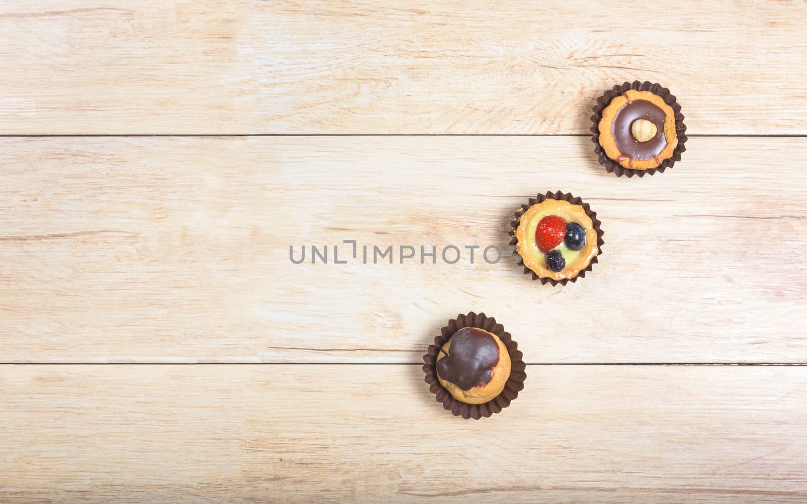 Pictured pastries on light wood background,above view with copy space.