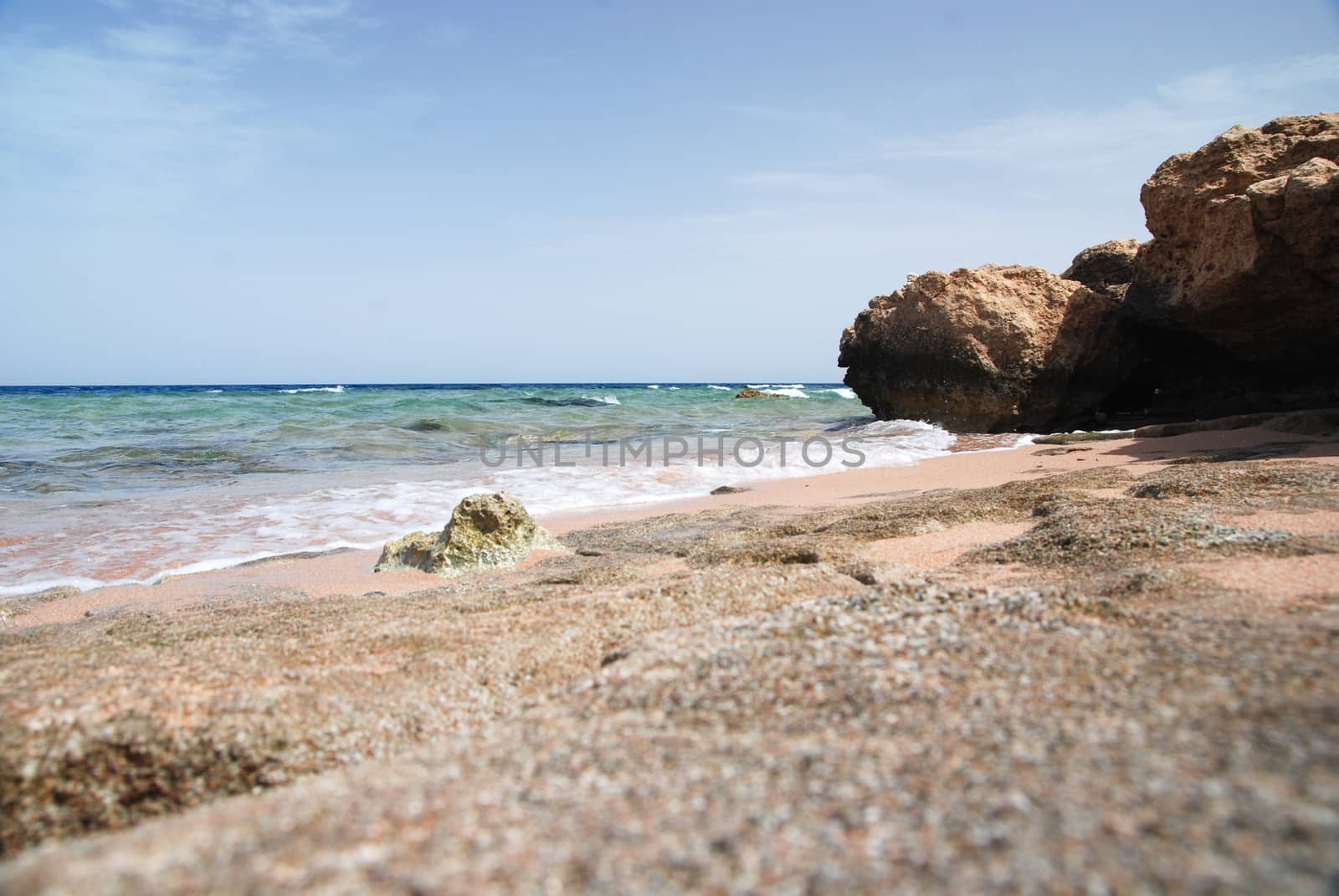 Photo of beautiful clear turquoise sea ocean water surface with ripples low waves on seascape sand beach background, horizontal picture.