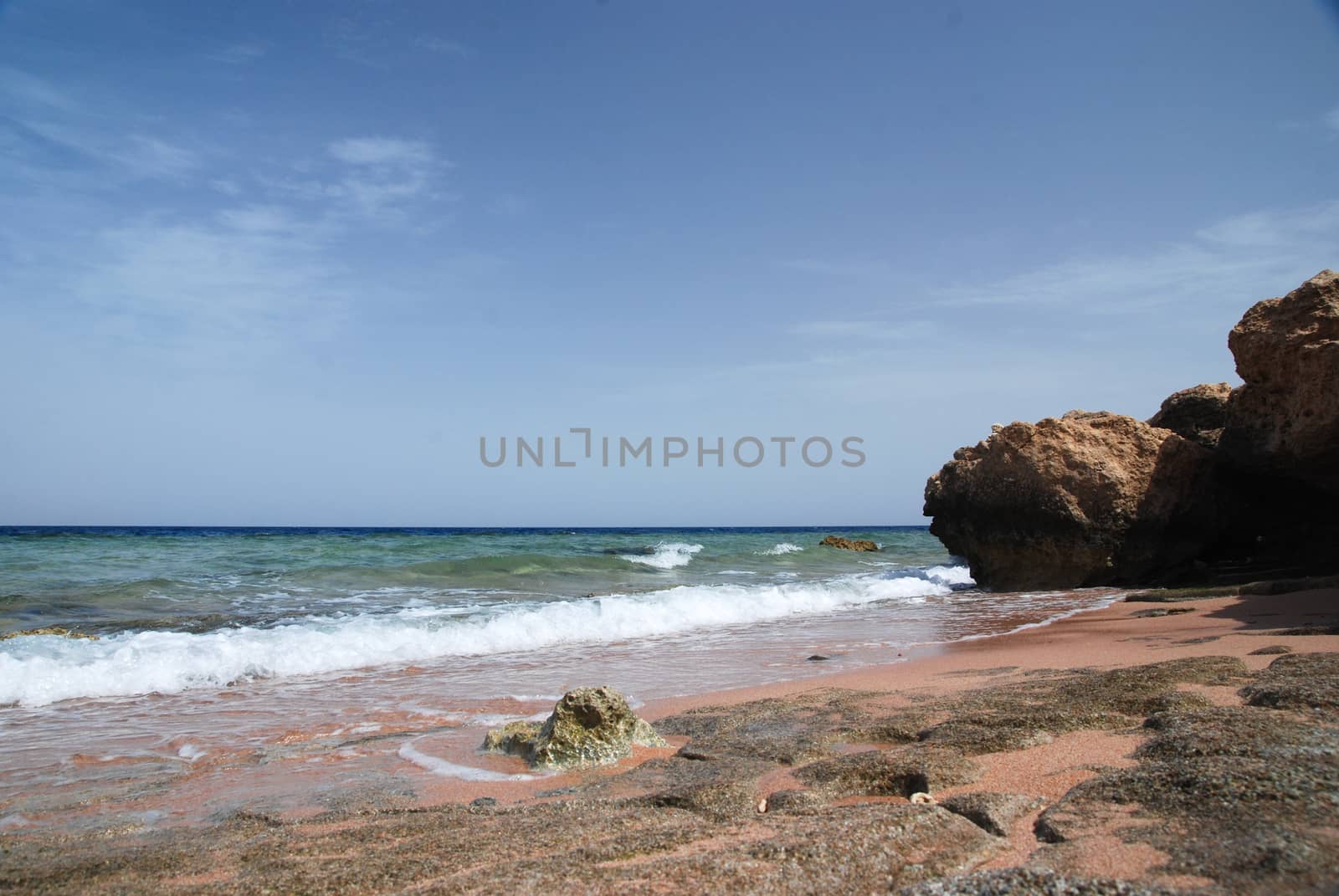 Photo of beautiful clear turquoise sea ocean water surface with ripples low waves on seascape sand beach background, horizontal picture.