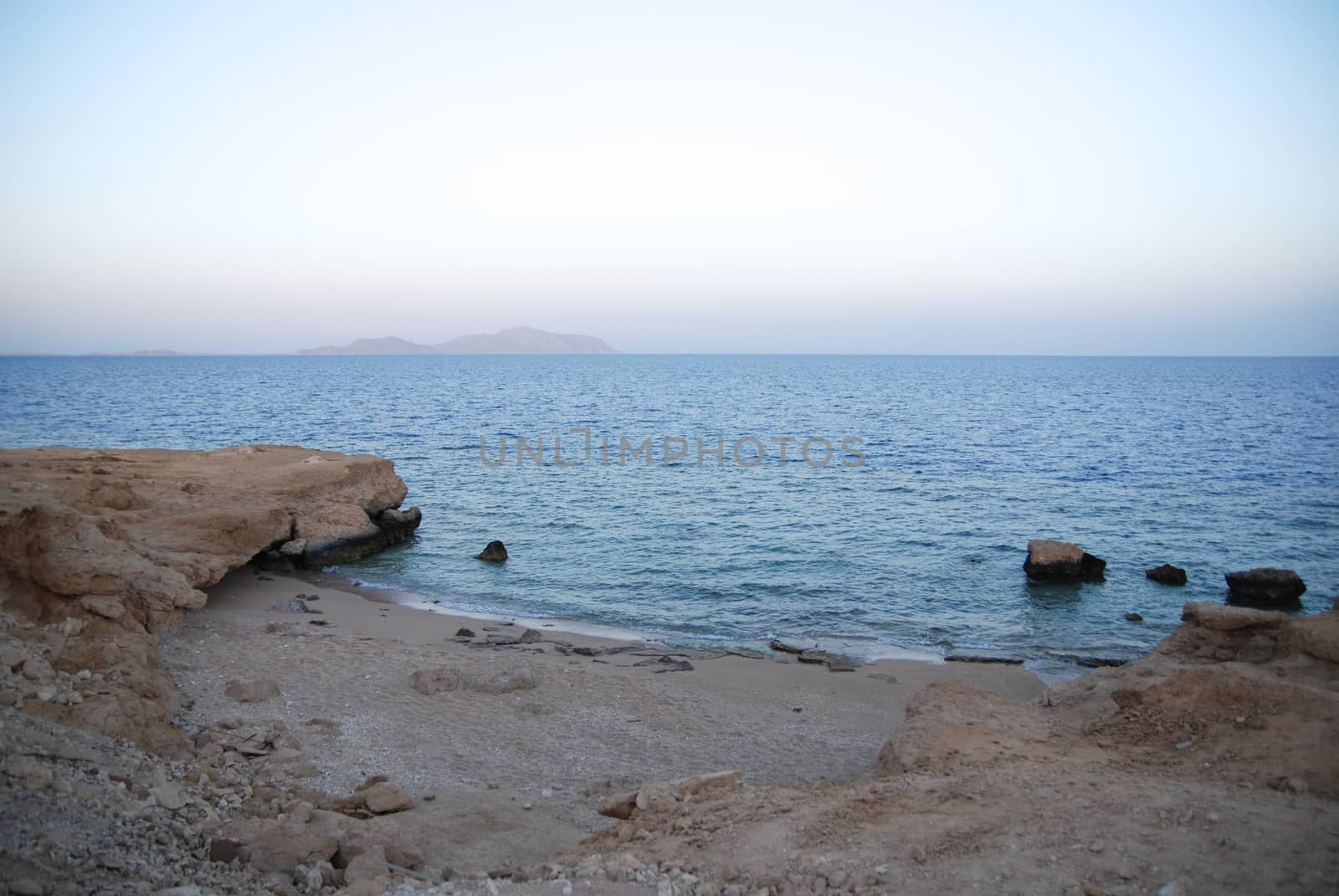 Photo of beautiful clear turquoise sea ocean water surface with ripples low waves on seascape sand beach background, horizontal picture by skrotov