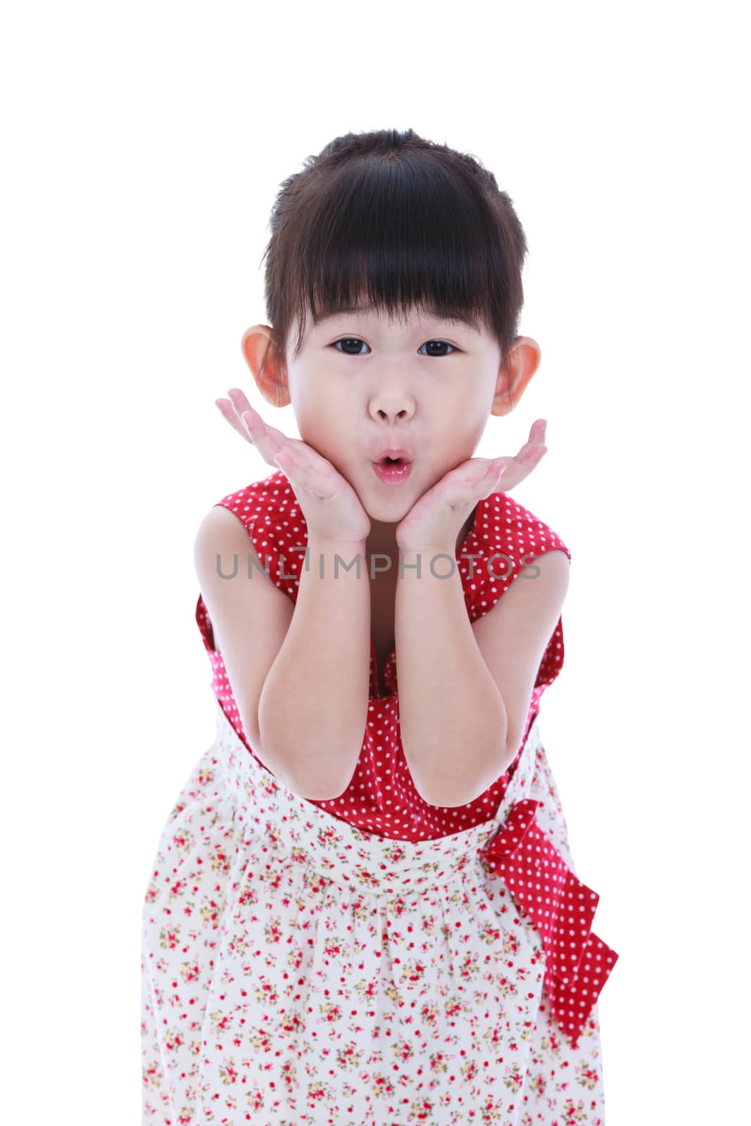 Wow. Adorable little asian girl in beautiful dress looking excited holding her mouth opened, hands on cheek. Shocked surprised stunned. Positive human emotion. Studio shot. Isolated on white background