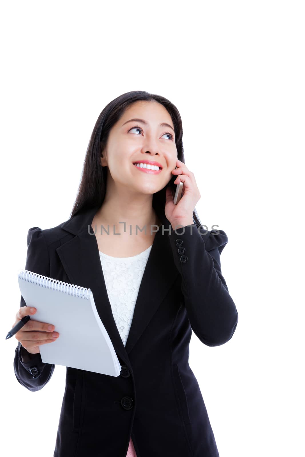 Young happy businesswoman talking on mobile phone and holding note paper. Isolated on white background. Positive human emotion. Studio shot.