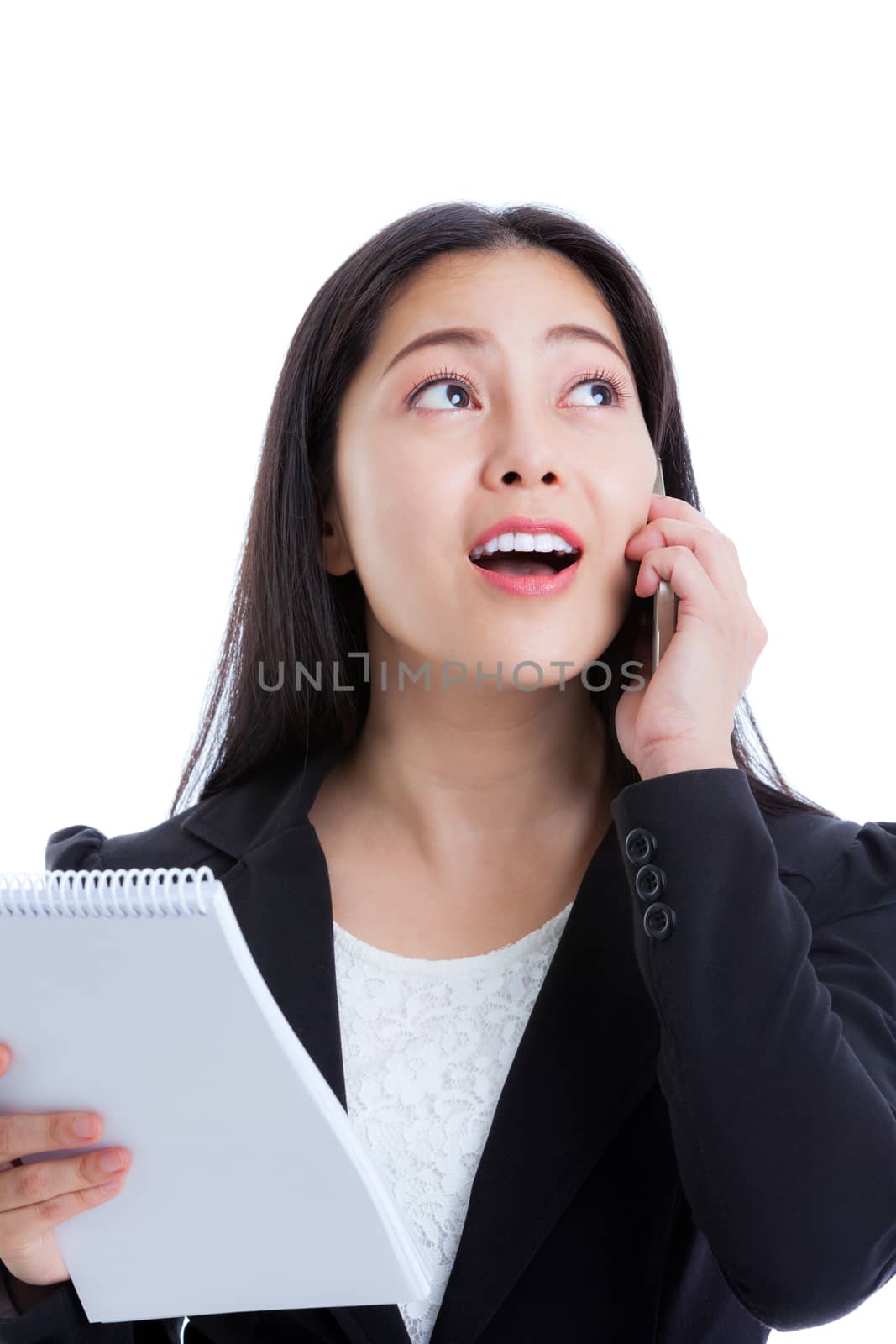 Close up of young happy businesswoman talking on mobile phone and holding note paper. Isolated on white background. Positive human emotion. Studio shot.