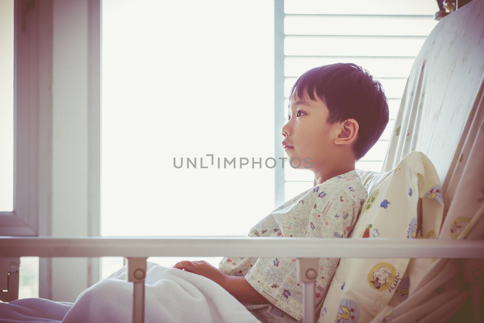 Illness asian child admitted at modern and comfortable equipped hospital room. Health care and people concept. Vignette and vintage style.
