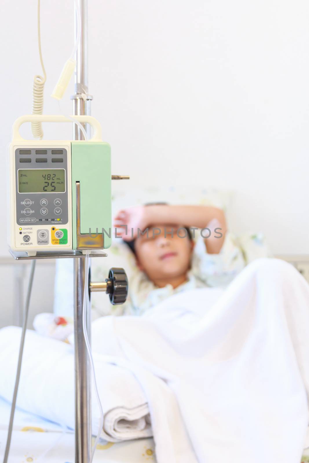 Asian boy sleeping on sickbed with infusion pump intravenous IV  by kdshutterman