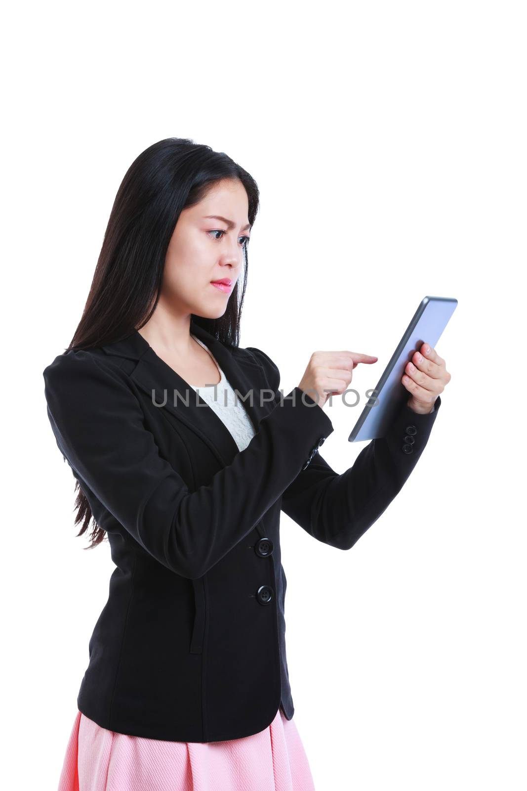 Young asian businesswoman is in an angry mood with her digital tablet. Negative human face expressions. Isolated on white background. Studio shot.