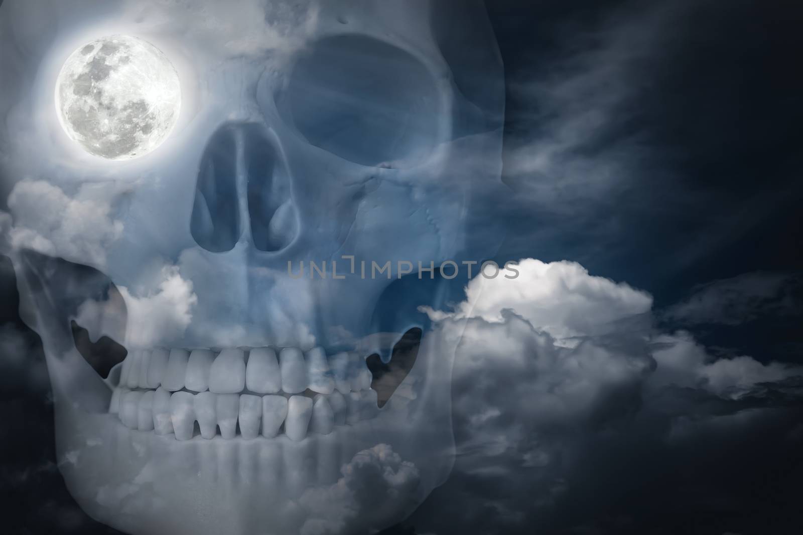 Halloween horror night background. Double exposure of human skull combined sky with clouds . Full moon on right eye socket. The moon taken with my own camera, no NASA images used.