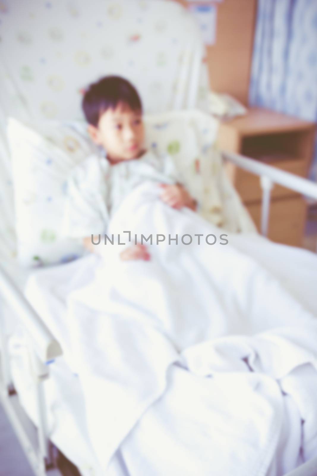 Abstract blurred background of illness asian child admitted at modern and comfortable equipped hospital room. Health care and people concept. Vintage style.