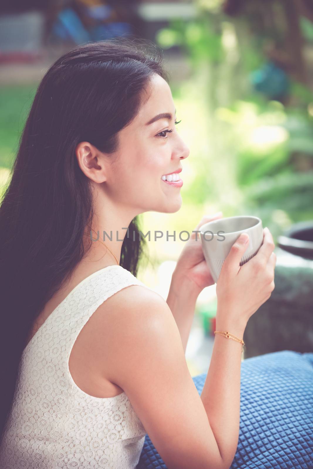 Beautiful asian woman enjoys fresh coffee in the morning. Happy  by kdshutterman
