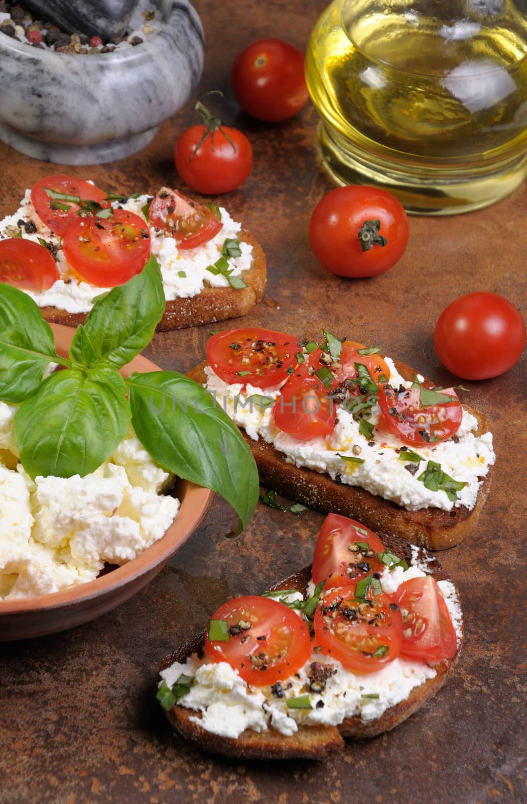 Bruschetta with ricotta and cherry tomatoes seasoned   spices, basil