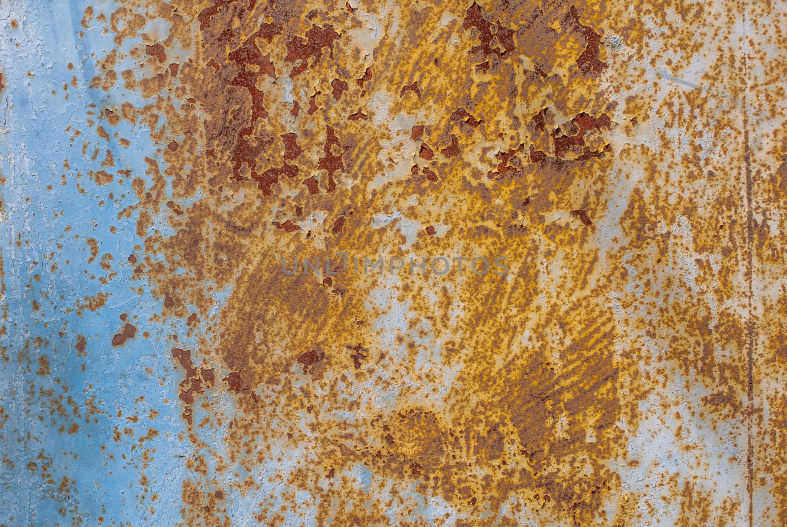 rusty iron surface covered with old chipped paint, which has long been influenced by different climatic conditions