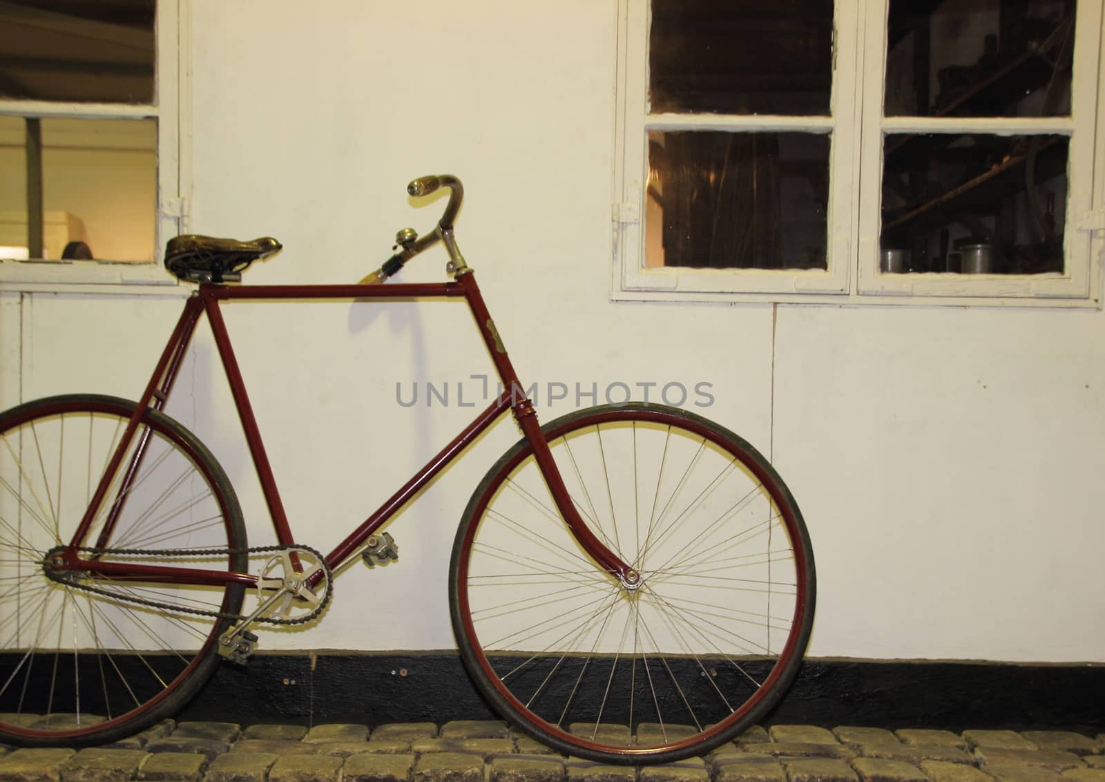 Single Old Simple Bicycle Leaning on White Wall
