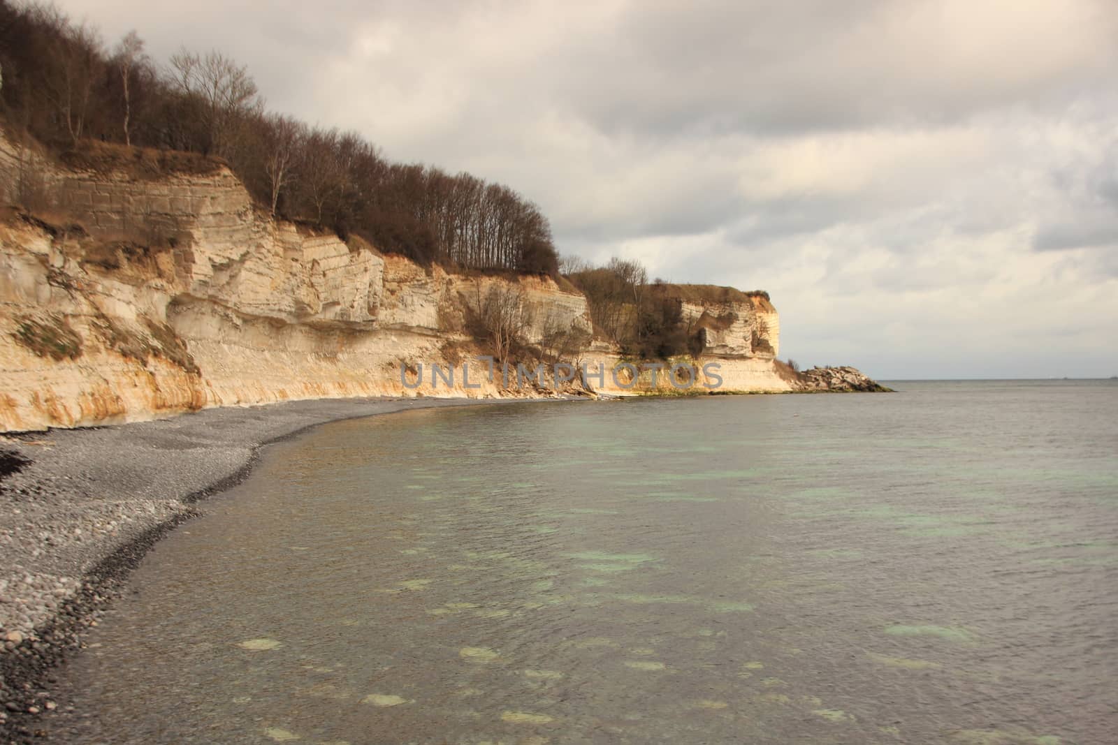 Denmarks Stevns Klint Coastline at sea level with White Cliff and Reflections from Limestone Clay