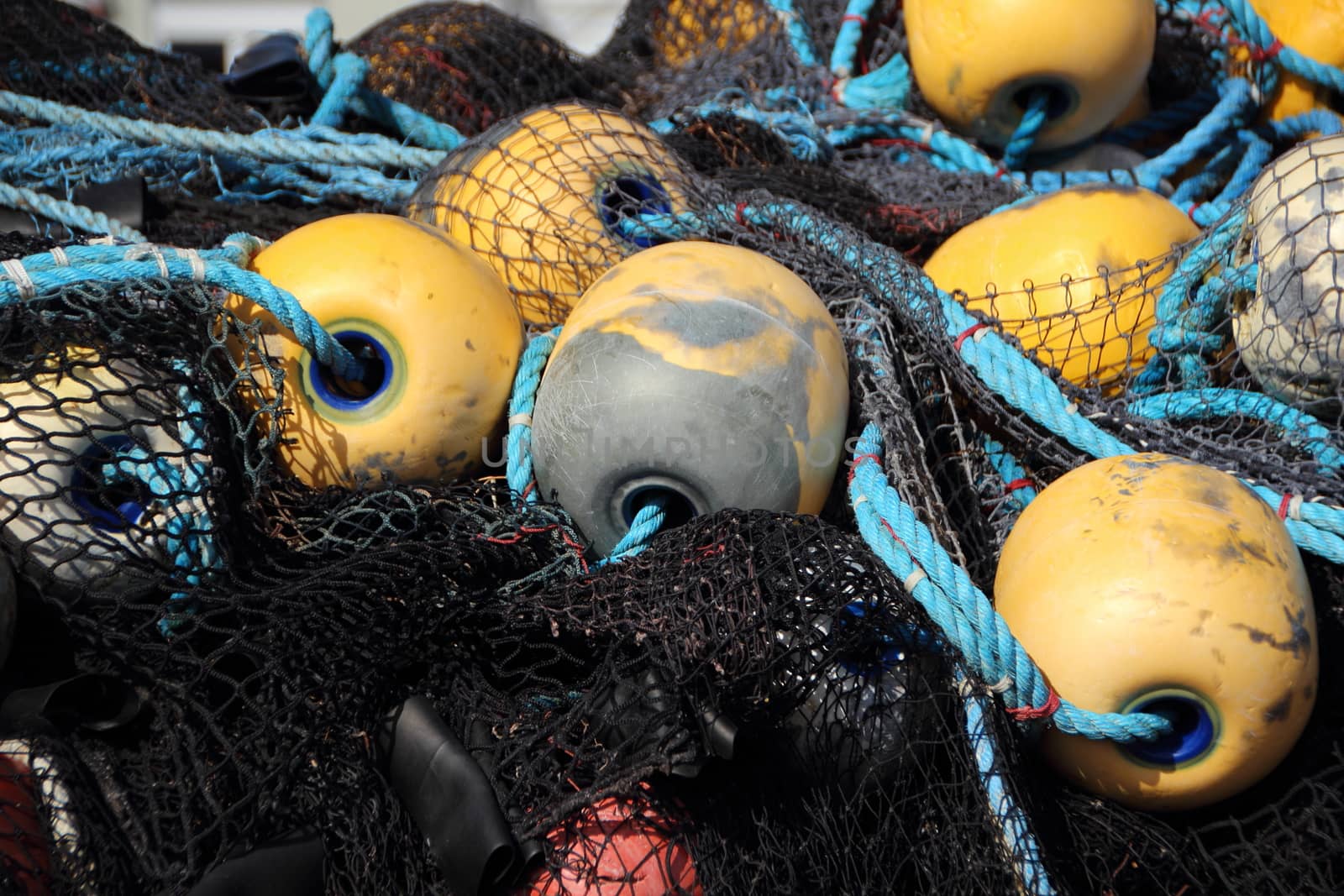 Isolated Fishing Net Pile with Yellow Floats by HoleInTheBox