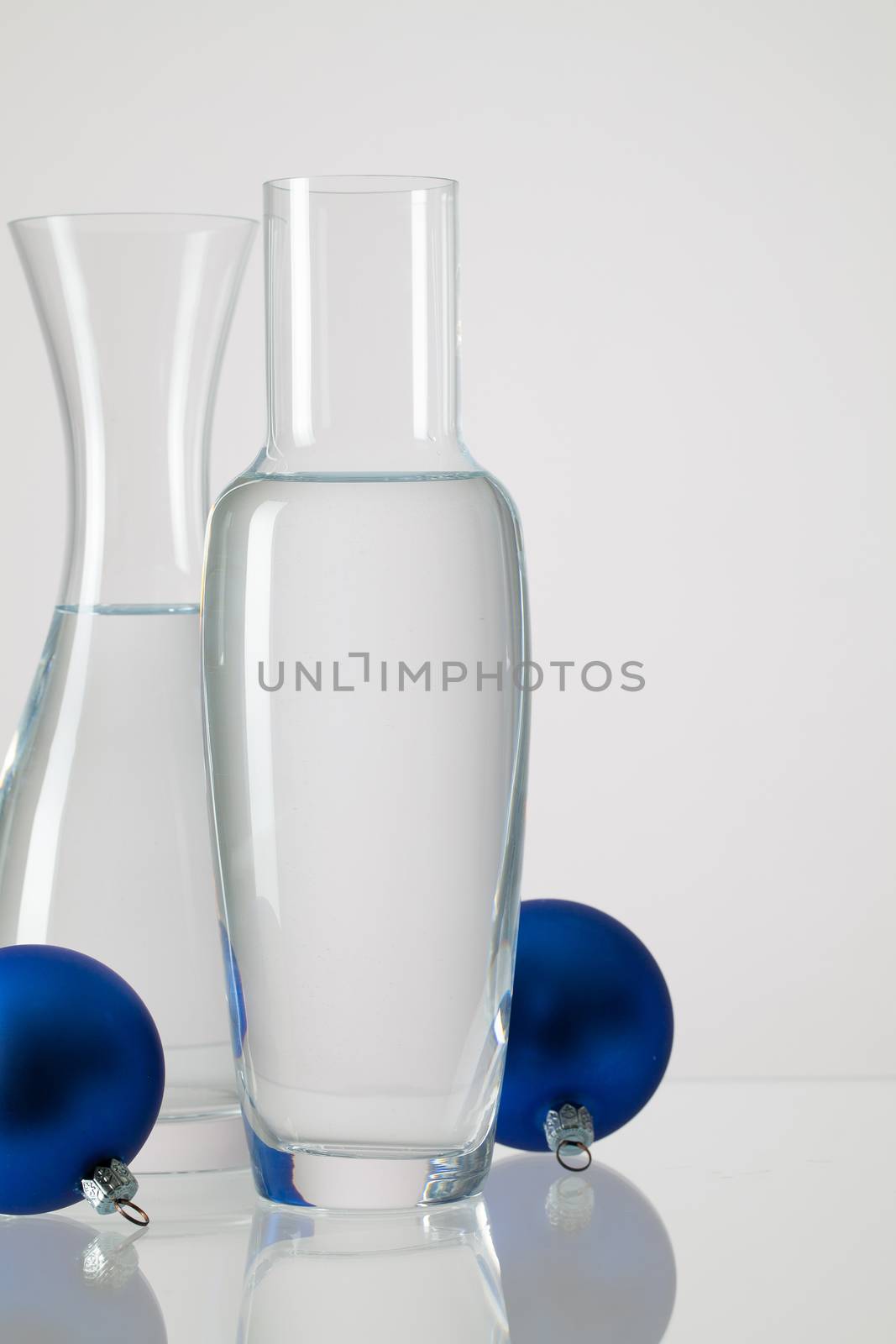 Two vases with clean water and Christmas decoration by CaptureLight