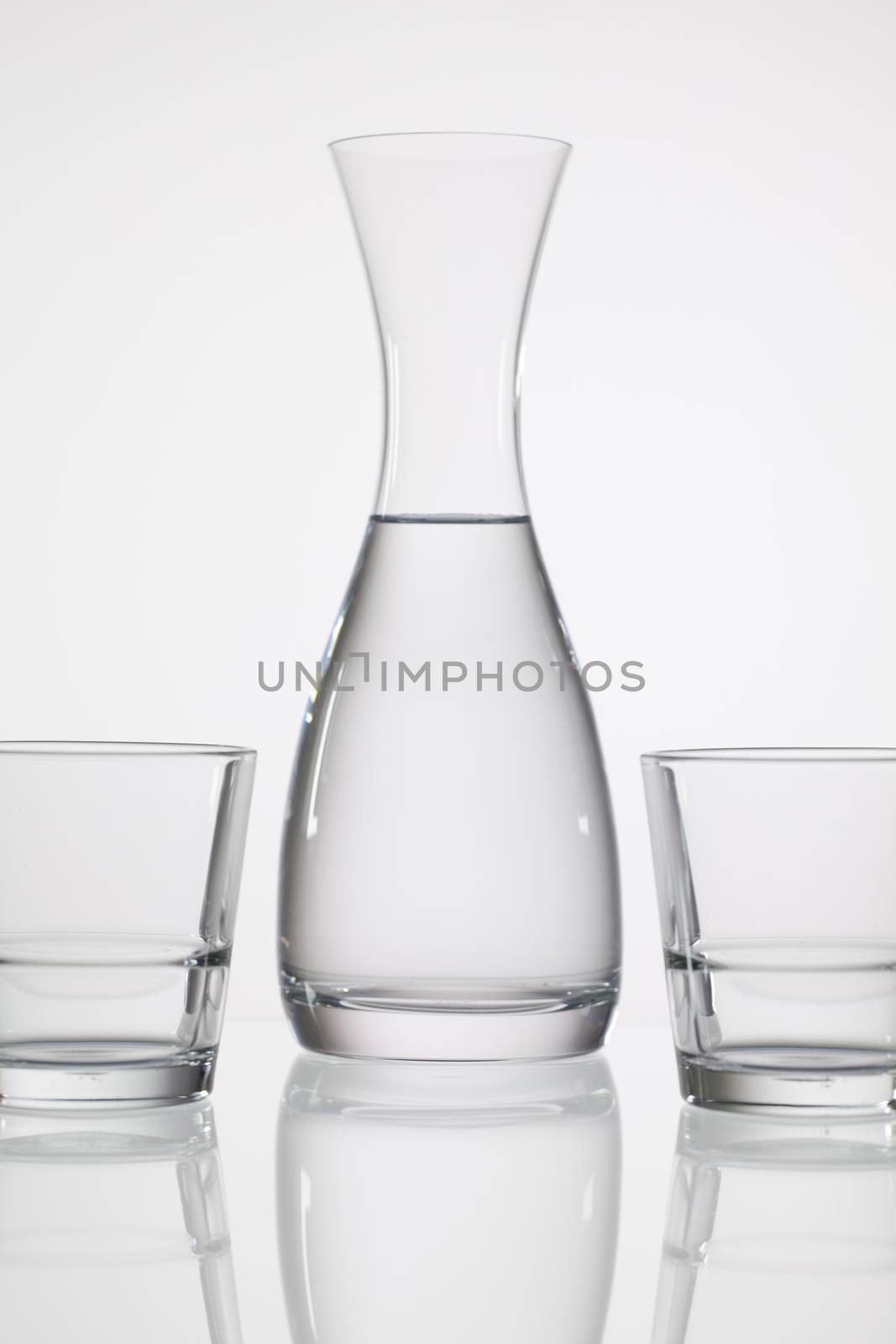 Glasses of water on the glass table  by CaptureLight