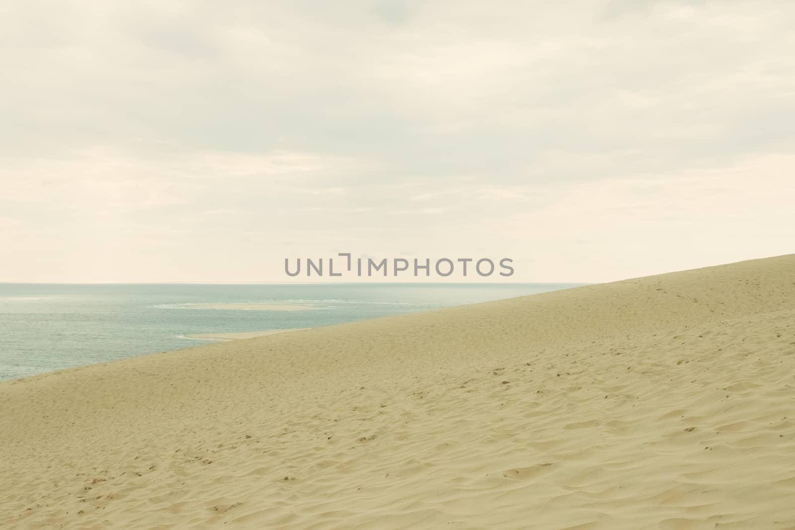 Sand, sea and sky. Retro styled image.