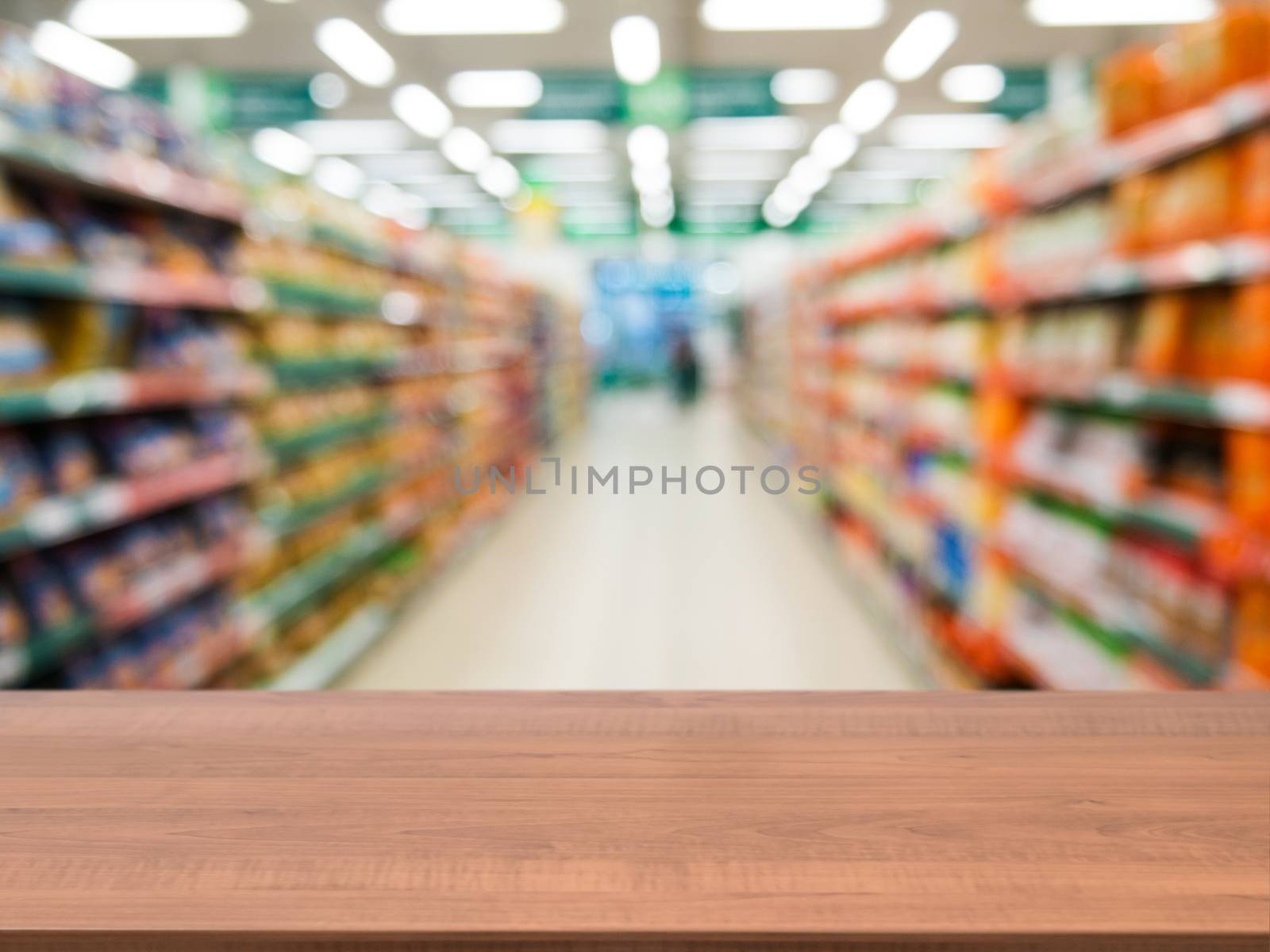Wooden empty table in front of blurred supermarket by fascinadora