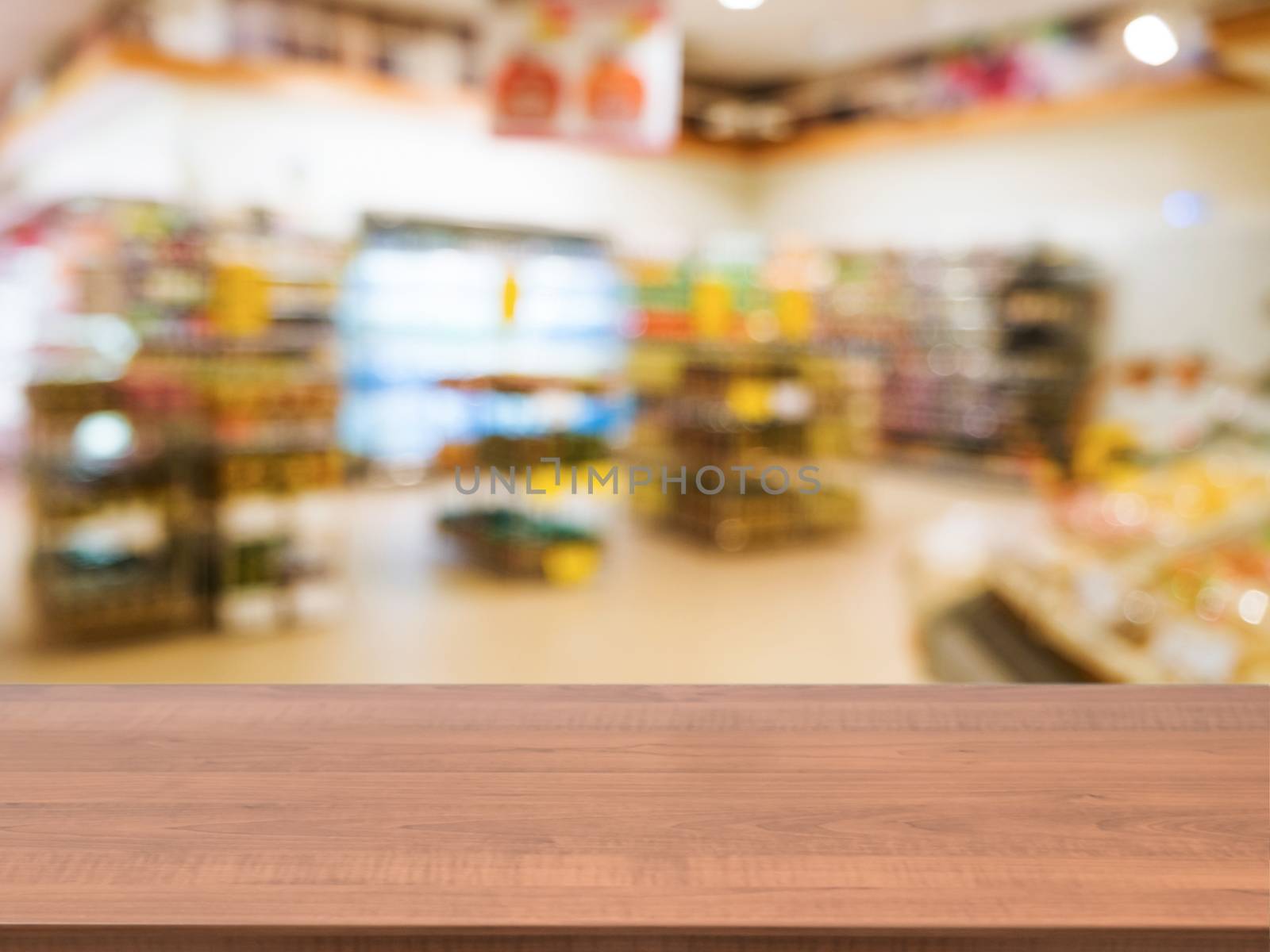 Wooden empty table in front of blurred supermarket by fascinadora