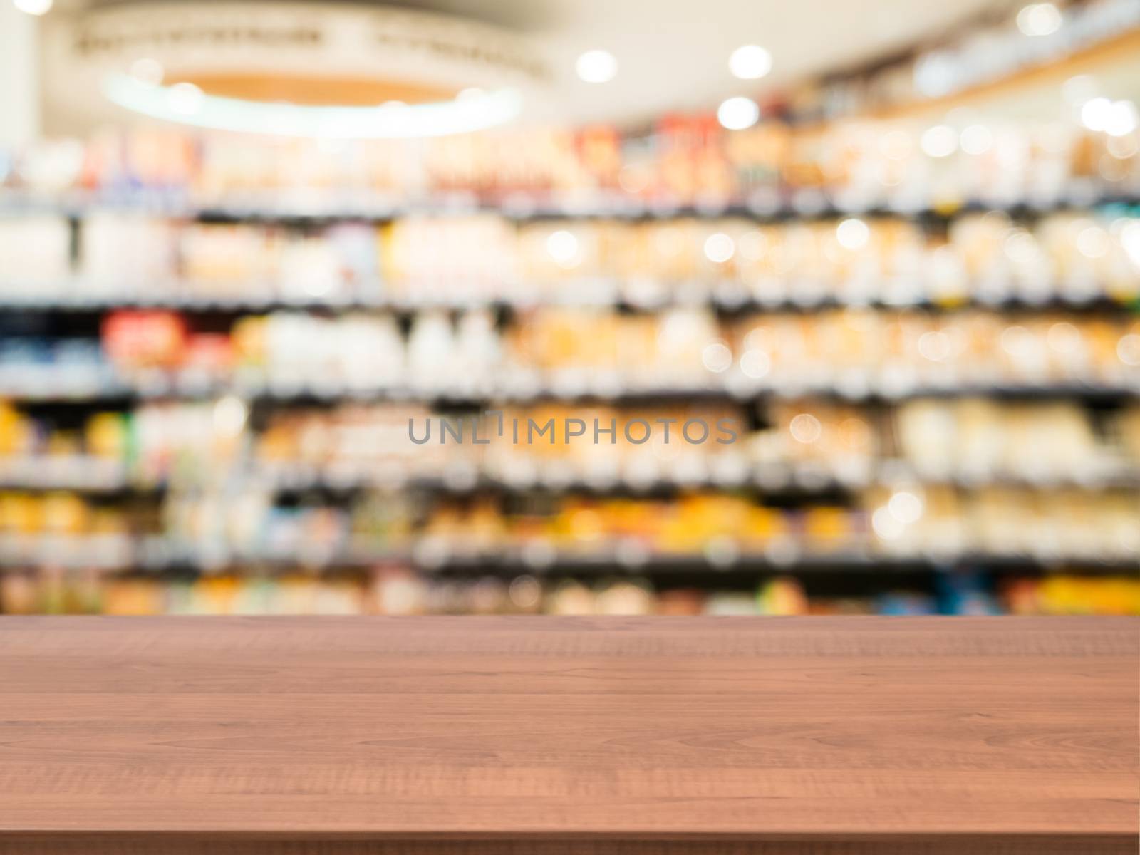 Wooden empty table in front of blurred supermarket by fascinadora