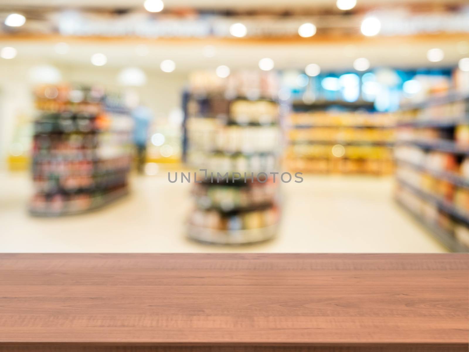 Wooden empty table in front of blurred supermarket by fascinadora