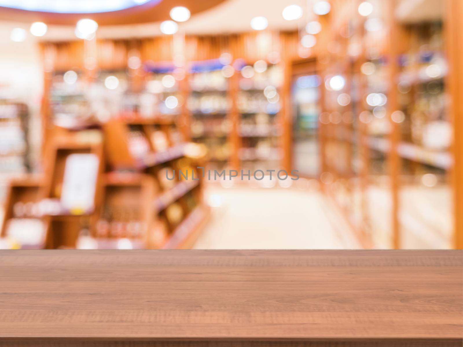Wooden board empty table in front of blurred background. Perspective dark wood over blur in department of alcoholic drinks in supermarket - Mock up for display or montage your products