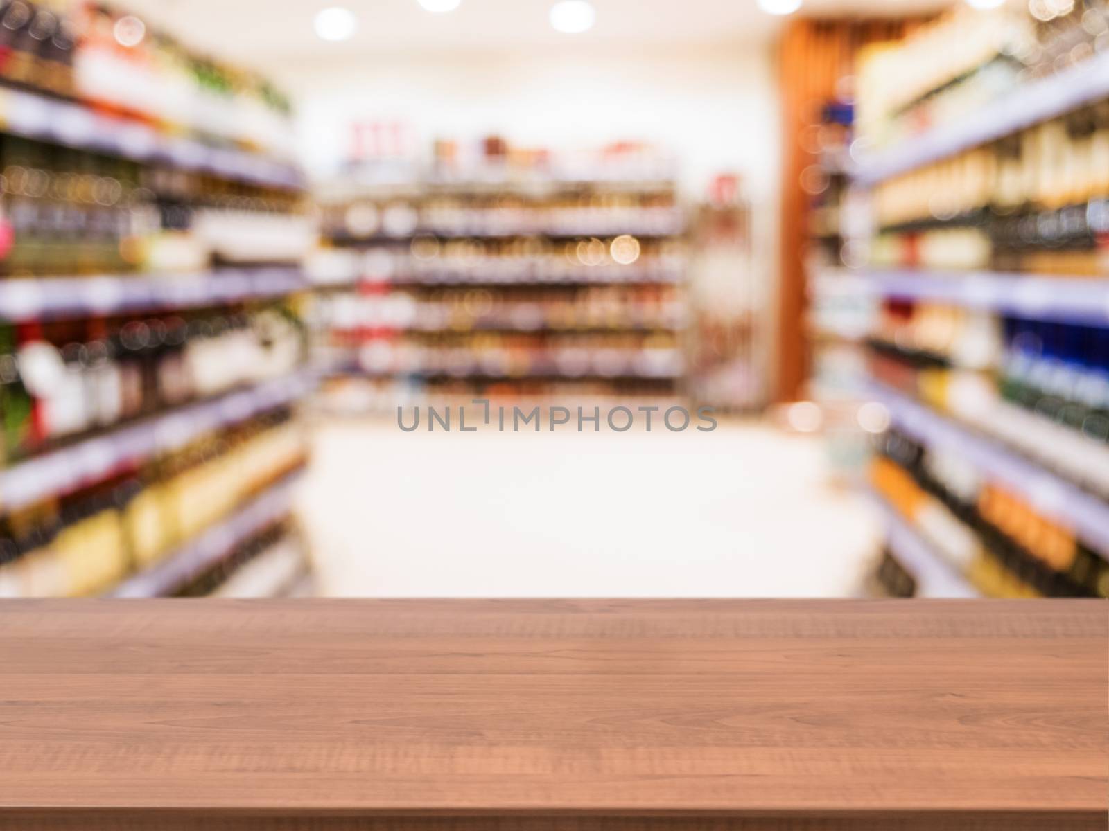 Wooden empty table in front of blurred supermarket by fascinadora