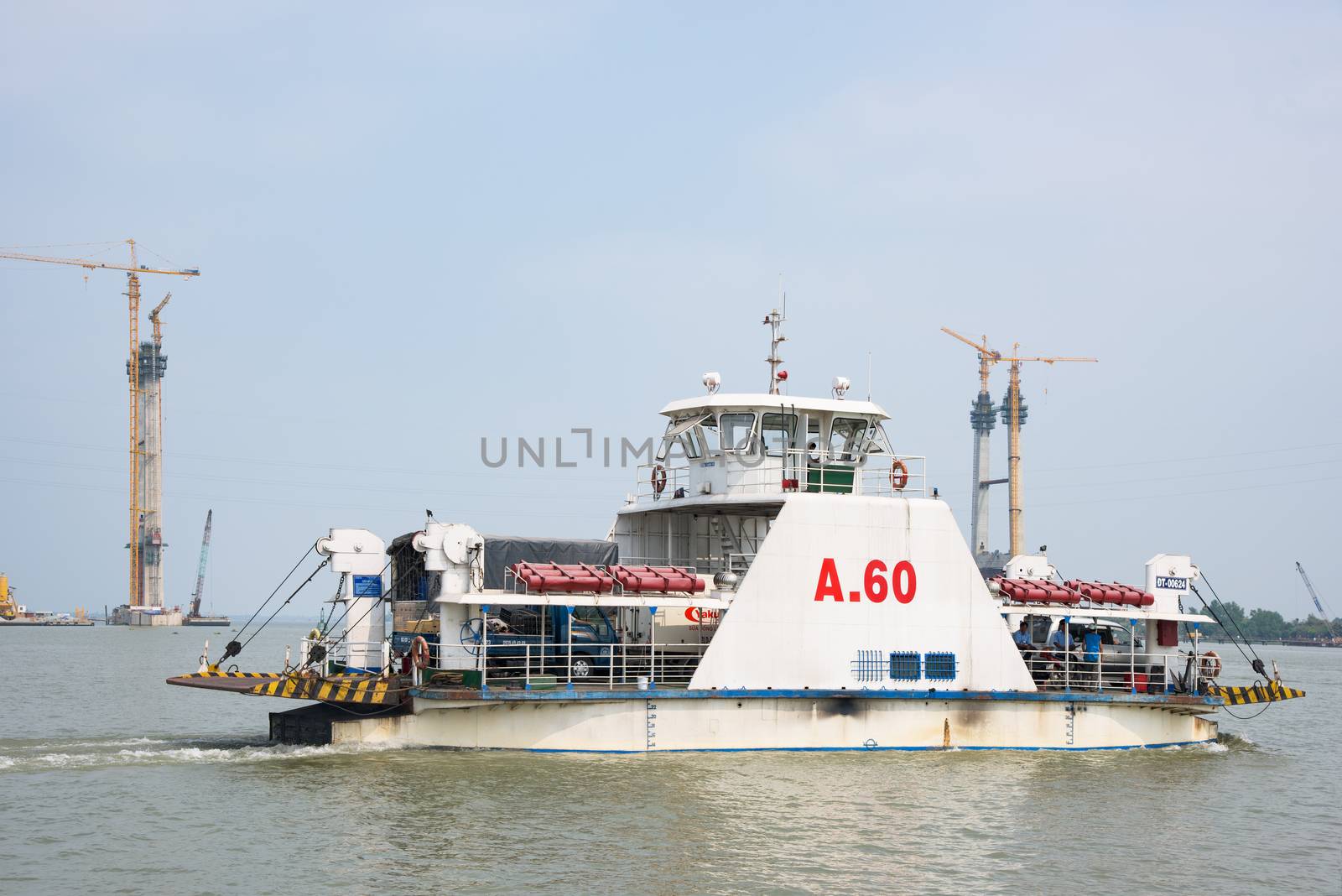 Cao Lanh, Vietnam - March 17, 2016: Car ferries in the Mekong Delta of Vietnam are rapidly being replaced by motorway bridges, like here near Cao Lanh, the capital of Dong Thap Province.