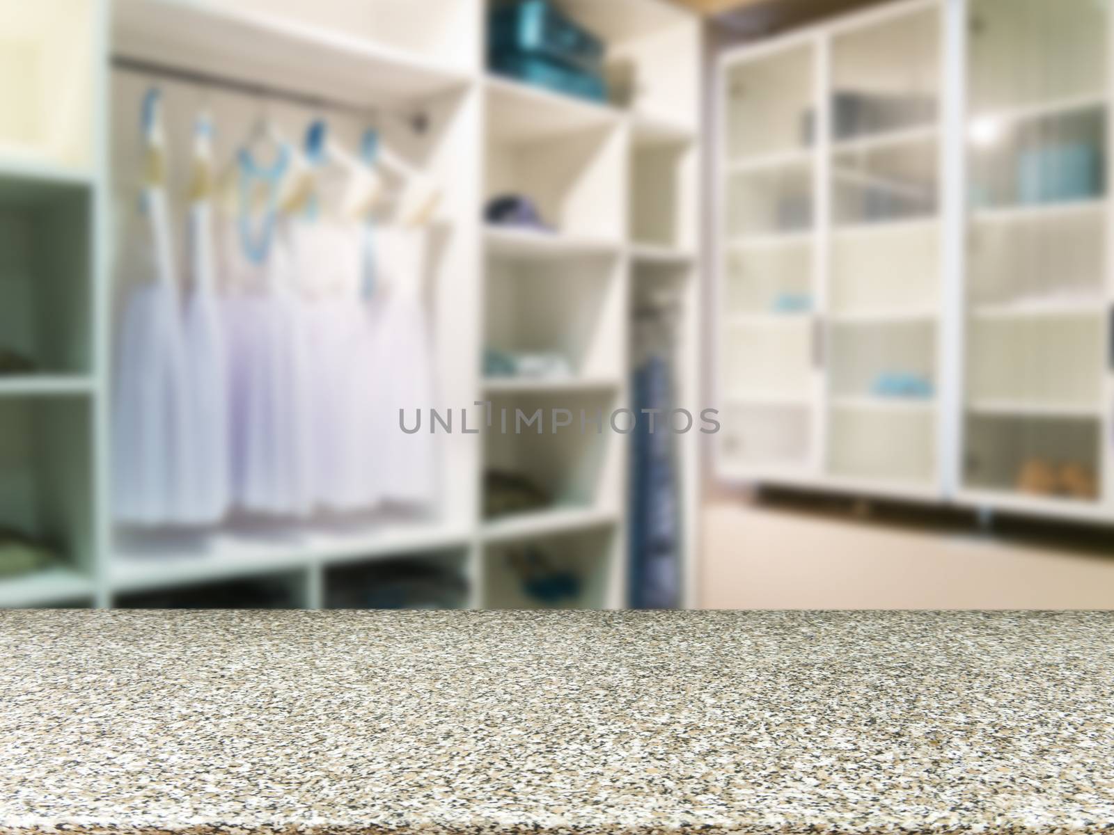 Marble board empty table in front of blurred background. Perspective light wood over blur in closet room for background uses. Mock up for display or montage your products