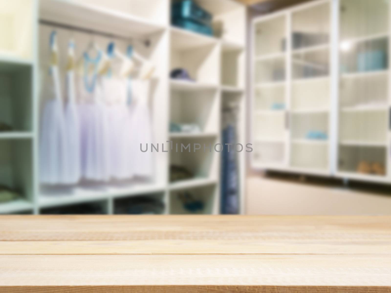 Wooden board empty table in front of blurred background. Perspective light wood over blur in closet room for background uses. Mock up for display or montage your products