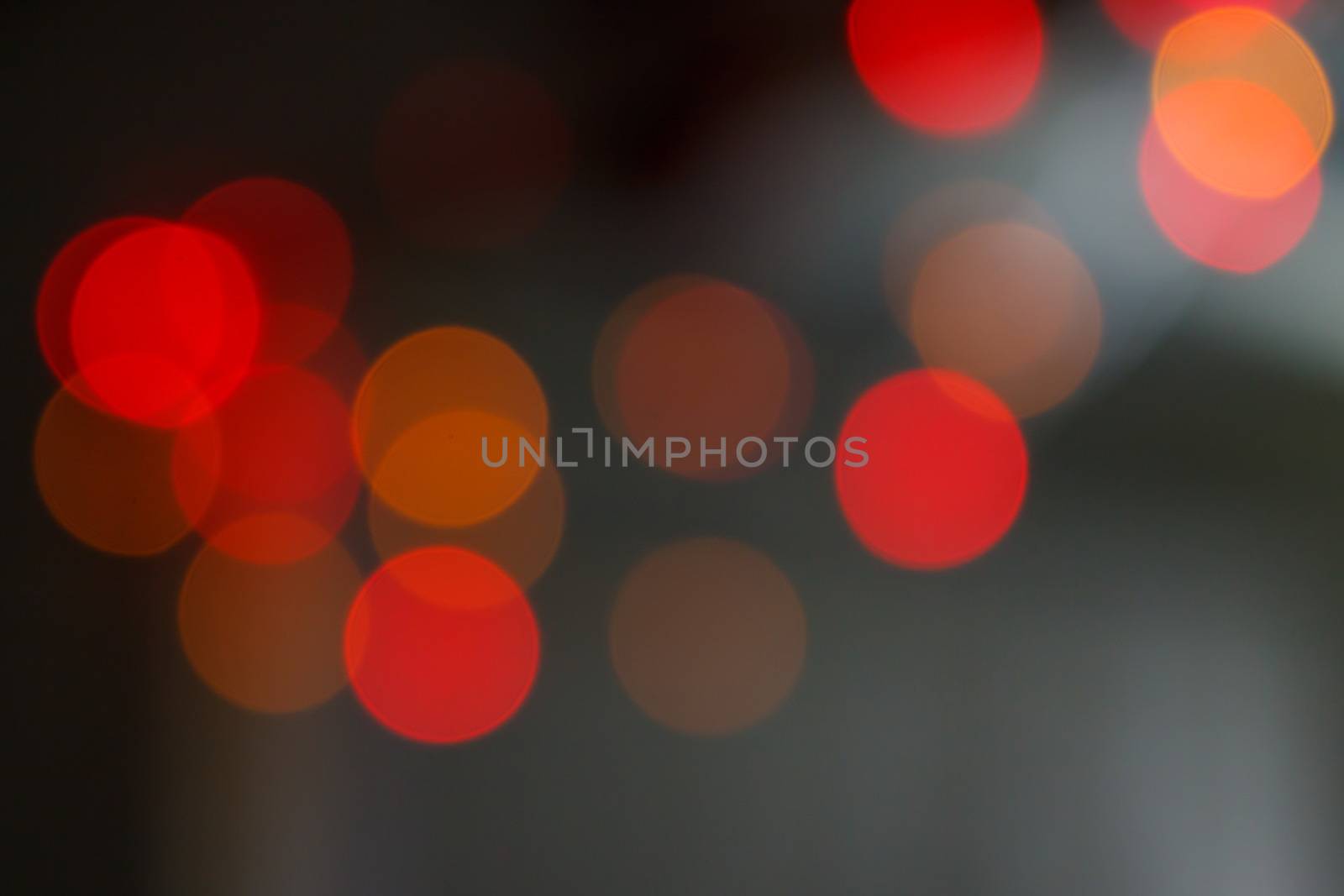 Red bokeh shimmering blur spot lights on abstract background by worrayuth