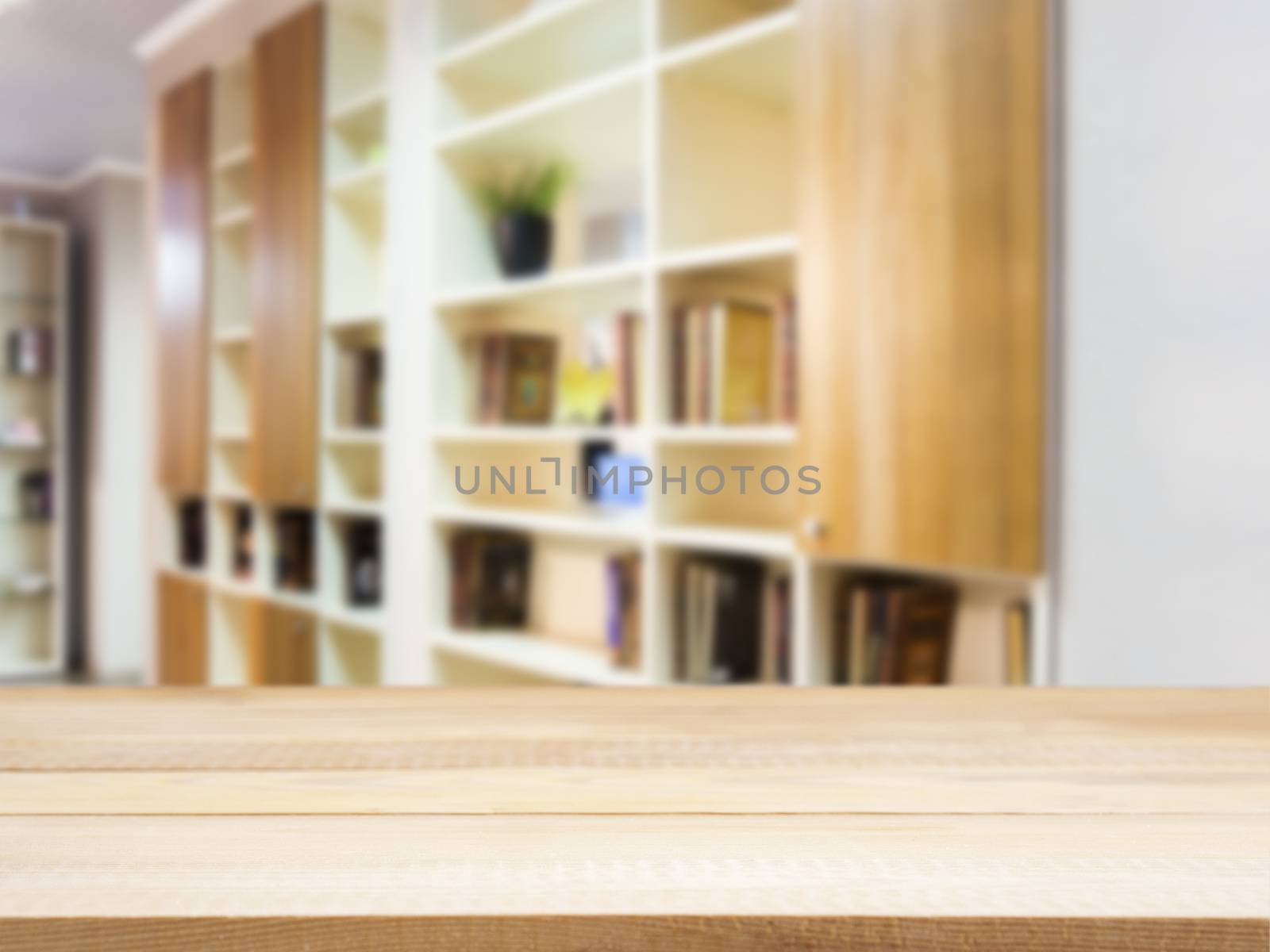 Wooden board empty table in front of blurred background. Perspective light wood over blur in modern living room interior. Mock up for display or montage your products