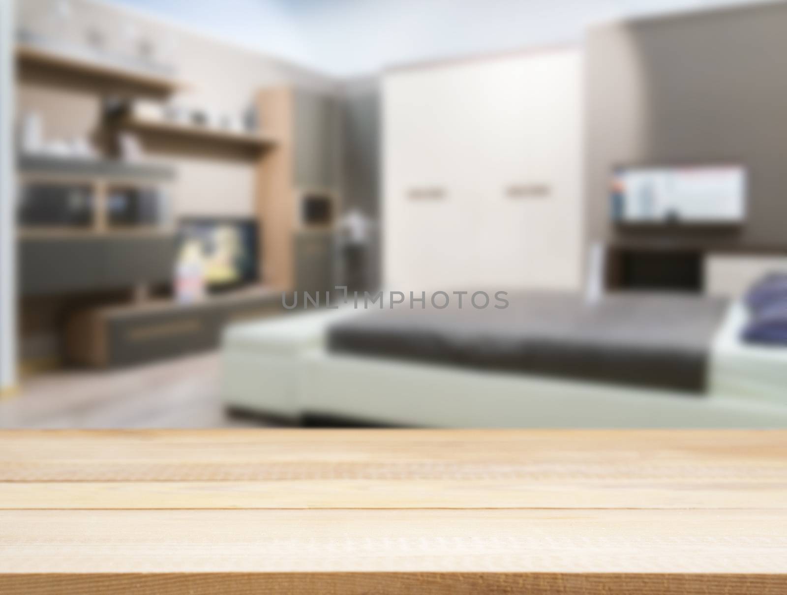 Wooden board empty table in front of blurred background. Perspective light wood over blur in modern comfortable bedroom with white bed. Mock up for display or montage your products