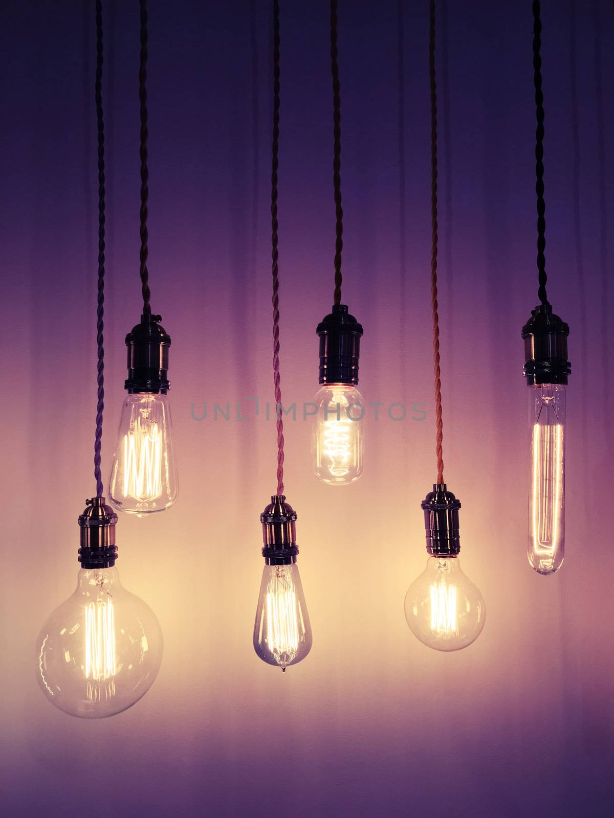 Industrial style light bulbs on purple background. Modern design with retro feel.